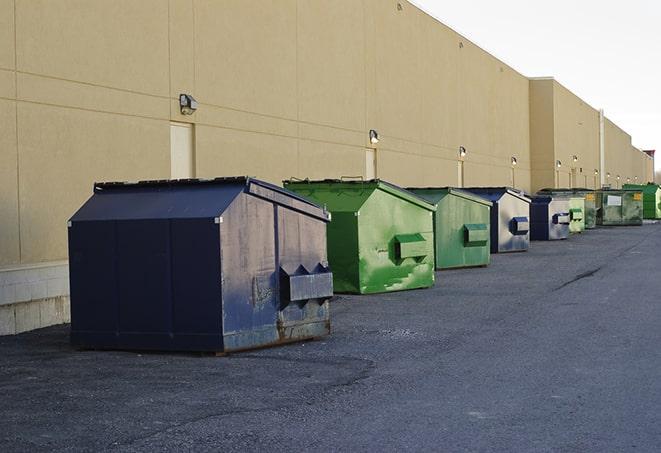 a series of colorful, utilitarian dumpsters deployed in a construction site in Brownsboro